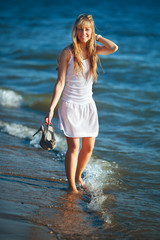 pretty woman in a white dress on the ocean coast