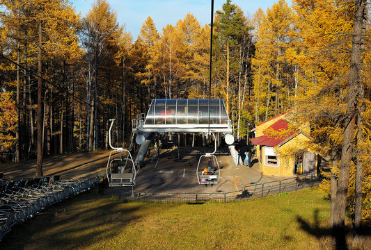 Landing place on chair lift in autumn mountain forest