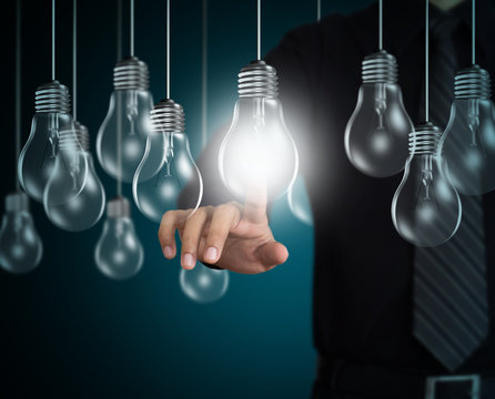 Businessman hand pointing at light bulb, Idea concept