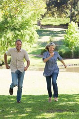 Obraz premium Couple running in park