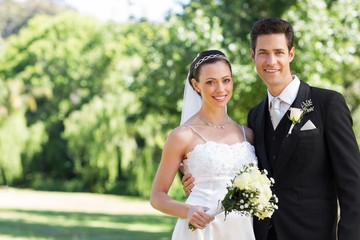 Newly wed couple smiling in garden