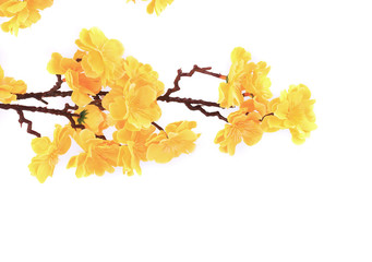 Artificial branch with yellow flowers.
