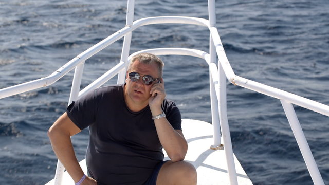Phone talk on sailing yacht