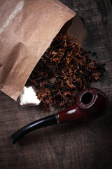 tobacco  and pipe on  wooden surface