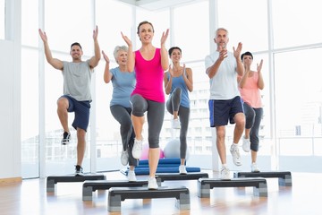 Portrait of smiling people doing power fitness exercise