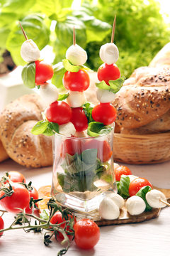 Caprese salad. Skewers with tomato and mozzarella with basil