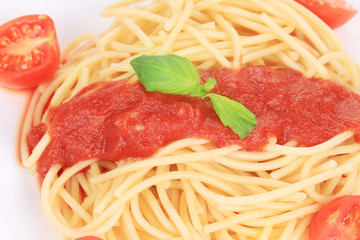 close up of spaghetti with tomato sauce and basil