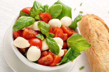 Caprese salad. Tomato and mozzarella with basil.