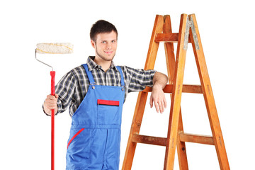 Male painter standing next to a ladder