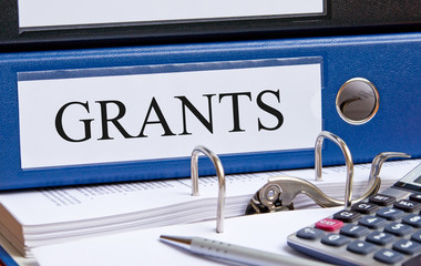 Grants - blue binder on desk in the office