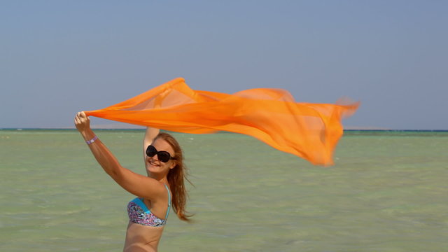 Young woman with pareo on the beach