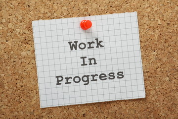 Work in Progress message on a cork notice board