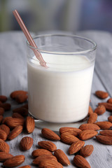 Almond milk in glass with almonds,