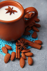 Fototapeta na wymiar Almond milk in jug with almonds in bowl,