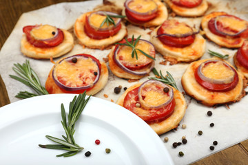 Small pizzas on baking paper close up