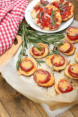 Small pizzas on baking paper close up