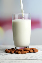 Almond milk is poured into glass,
