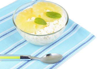 Bowl of tasty cottage cheese with pineapple, isolated on white