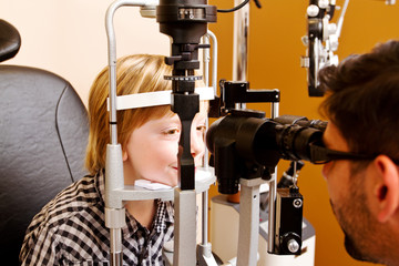 Optometrist checking childs vision