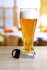 Composition with car key and glass of beer,