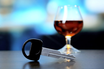 Composition with car key and glass of cognac,