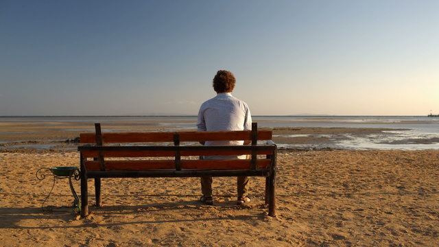 Man sitting alone on the beach
