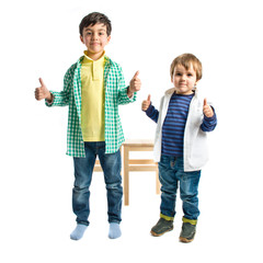 Boys making OK sign over white background