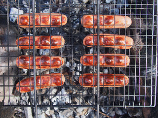 roast sausages on fire