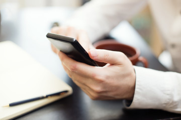 Man using smartphone, close-up photo
