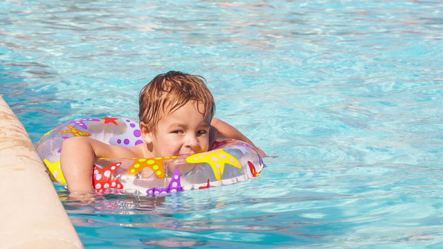 Boy swimming with inflatable ring