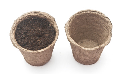 pile peat pots for growing seedlings, isolated on white backgrou