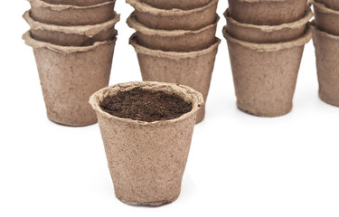 pile peat pots for growing seedlings, isolated on white backgrou