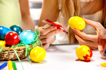 Fototapeta na wymiar Children paint Easter eggs at home.