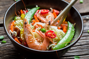 Closeup of chinese noodles, vegetables and prawns