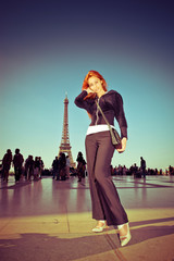 young woman against Tour d'Eiffel,with a retro effect