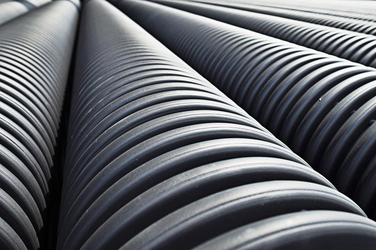 Close up of black plastic pipes with diminishing perspective