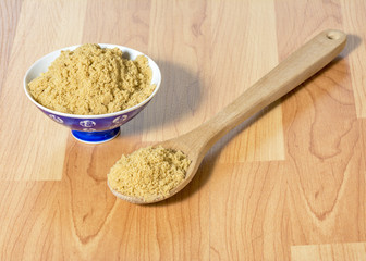 Surving brown sugar on a table