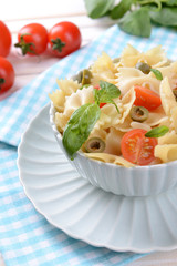 Delicious pasta with tomatoes on plate on table close-up