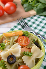 Delicious pasta with tomatoes on plate on table close-up