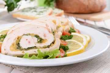 Delicious chicken roll on plate on table close-up
