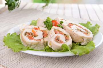 Delicious chicken roll on plate on table close-up