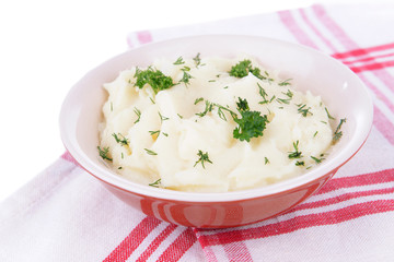 Delicious mashed potatoes with greens in bowl on table close-up