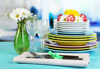 Stack of colorful ceramic dishes and flowers,