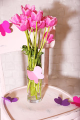 Composition with bouquet of tulips in vase,