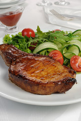 Grilled steak with vegetables on bone
