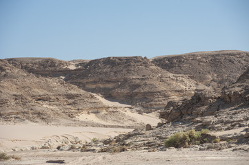 Dry river valley through a rocky desert
