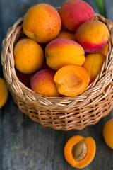 apricots in a basket on wooden background