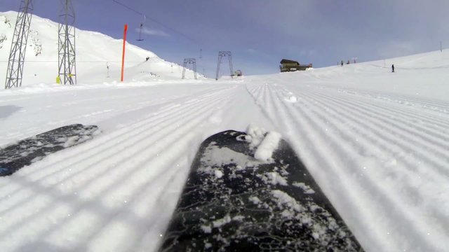 Skiing downhill rear view