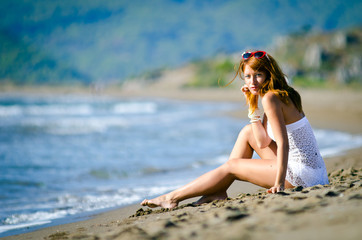 girl in a white bathing suit on the beach