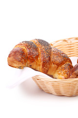 Image of croissant with poppy in a basket